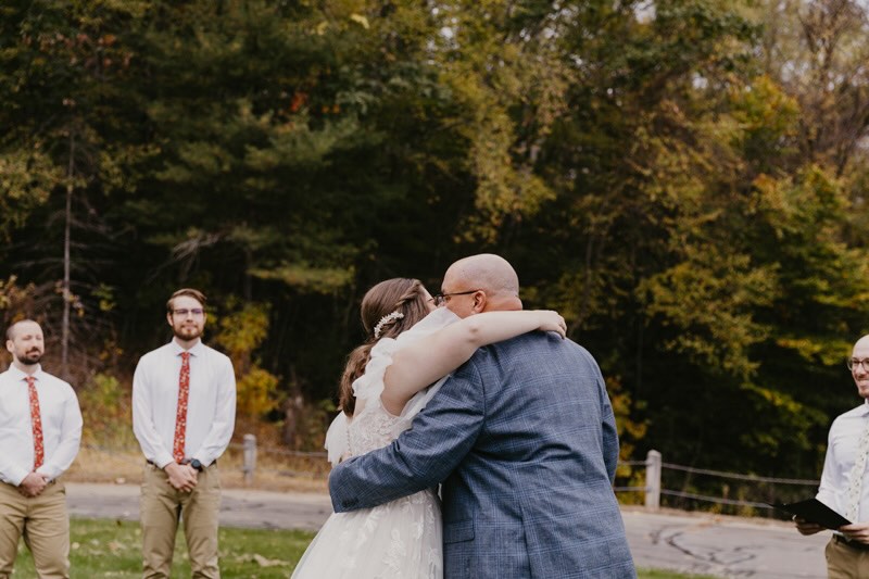 A dad and daughter embracing