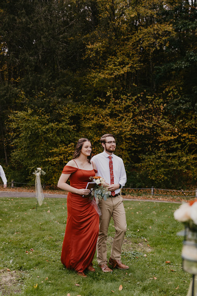 A groomsmen and bridesmaid walking