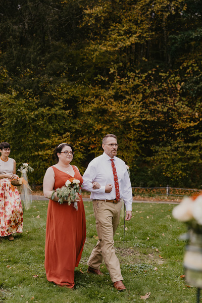 A groomsmen and bridesmaid walking