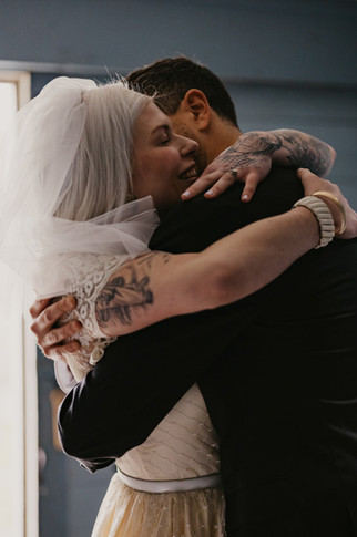 A couple embracing after getting married