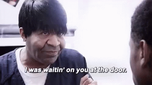 Black man in jail talking to a younger black man