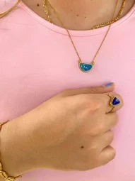 a girl wearing a set of waterproof bracelet, necklace and ring jewelry 