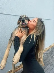a girl wearing gemstone ring with a dog
