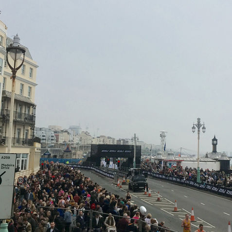 A Tune Truck DJ Truck surrounded by crowds at Brighton Marathon. 