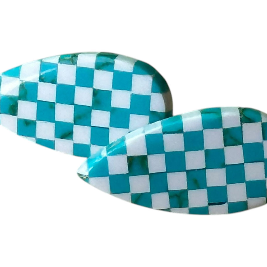 A pair of turquoise and white checkered pear shaped earrings.
