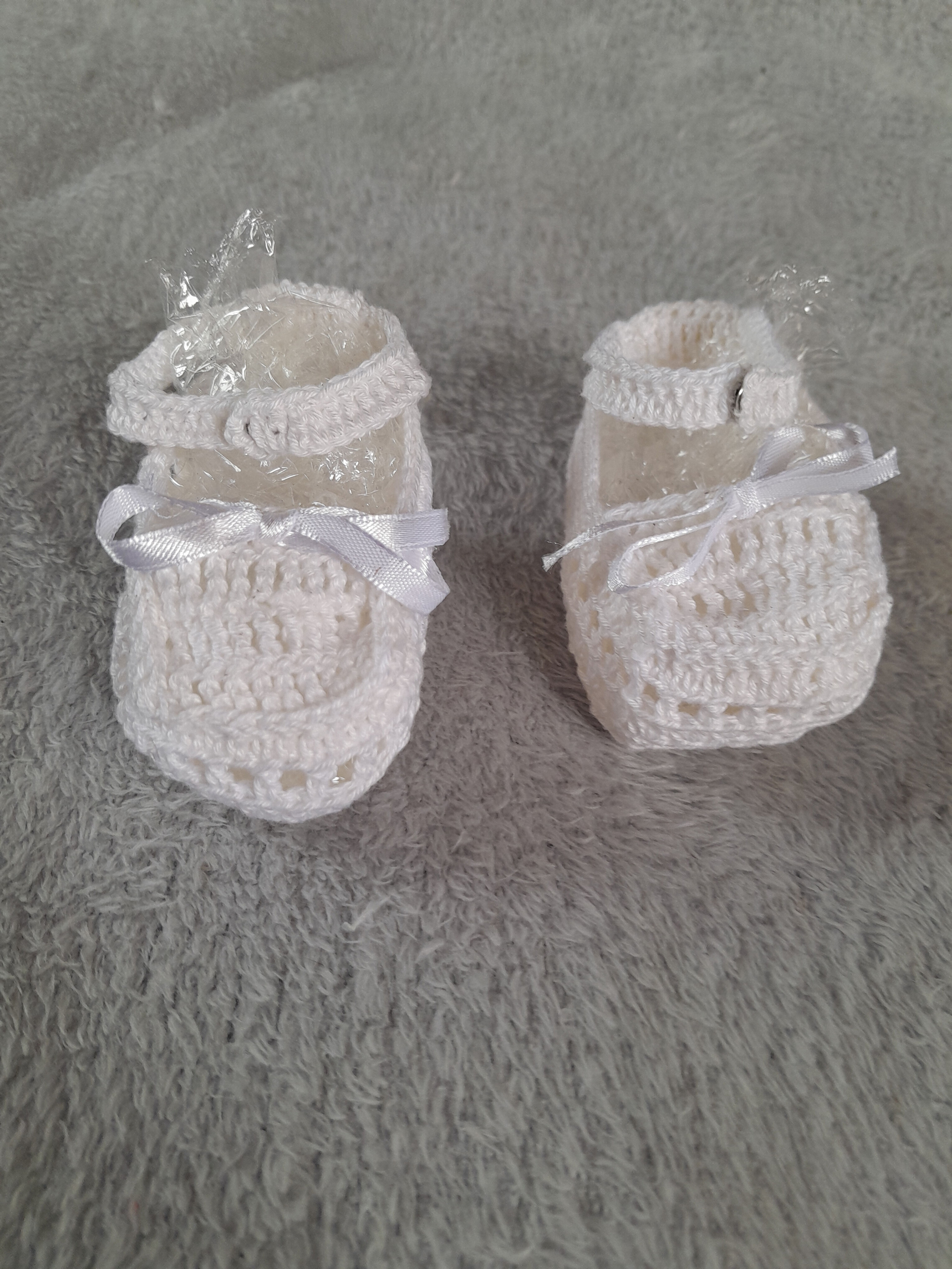 Chaussons blancs en crochet pour bébé avec ruban. Seconde main.