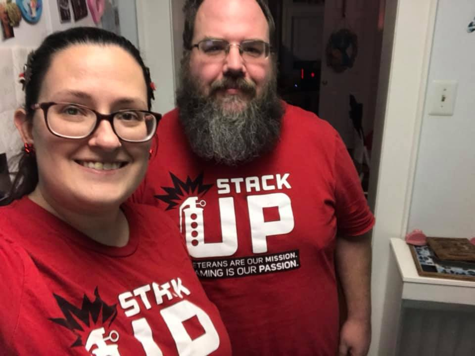 Two stack up stacks members smile while wearing their red stack up t shirts.
