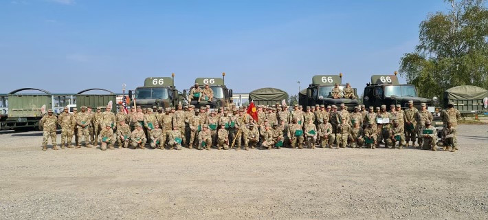Picture of about 40 soldiers all in uniform. Matthew's 88M unit all standing in front of the military transports that they drive.