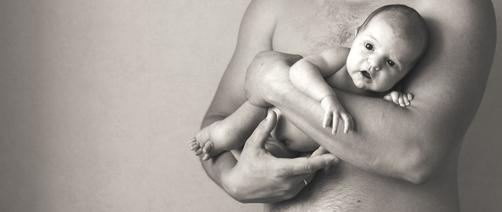closeup portrait of young father holding his newborn baby