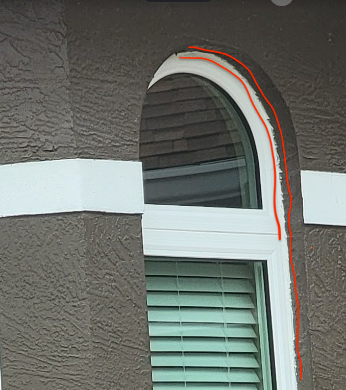 white caulk bleeding over onto brown stucco exterior paint