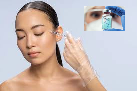 girl being injected, inset picture of face waring goggles, mask and blue gloves holding a vial