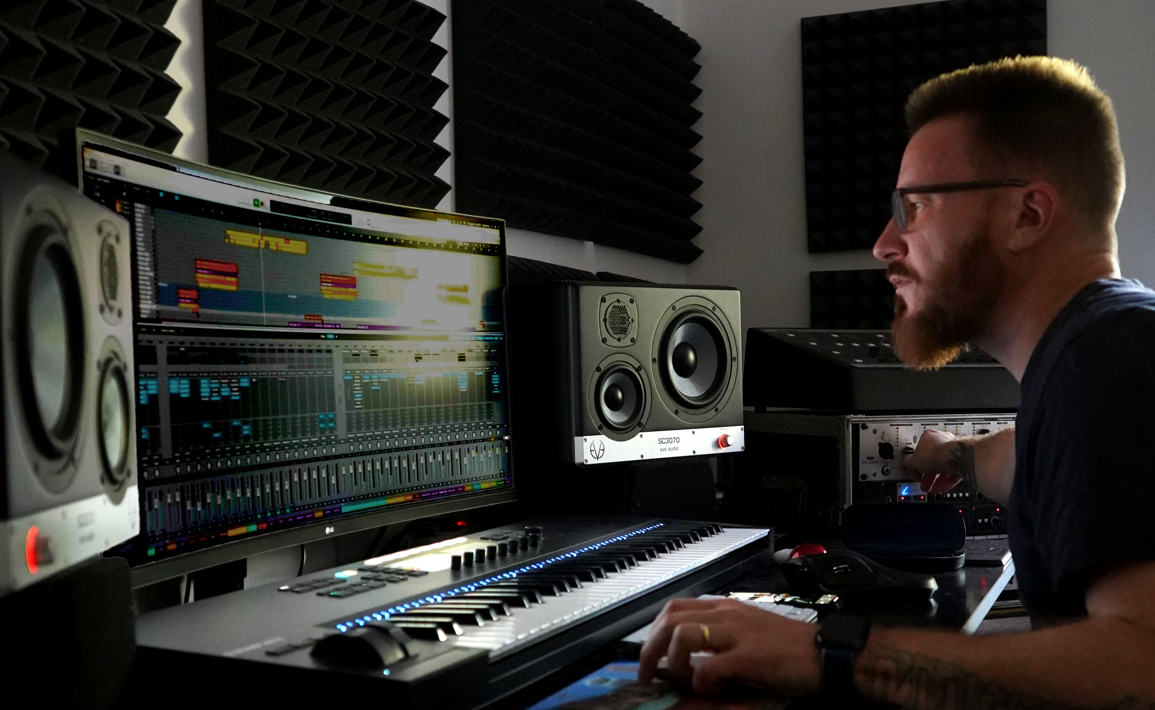 Rel McCoy at the computer monitor in the studio