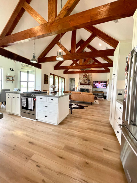 beautiful farmhouse style home featuring Sea Salt Oak with 9" planks and Soft Step attached underlayment in kitchen & living area. 