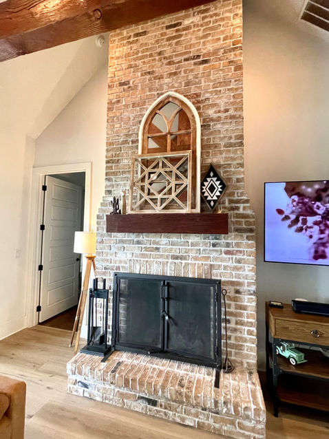 beautiful farmhouse style home featuring Sea Salt Oak with 9" planks and Soft Step attached underlayment in living area at the fireplace. 