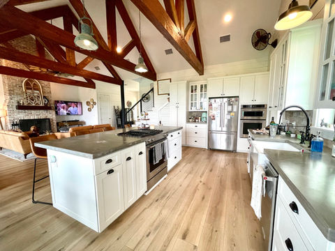 CoreTec flooring installed in the first story of a beautiful farmhouse style home featuring Sea Salt Oak with 9" planks and Soft Step attached underlayment.