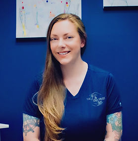 Danika - white woman with long blonde hair and blue shirt, in front of blue background