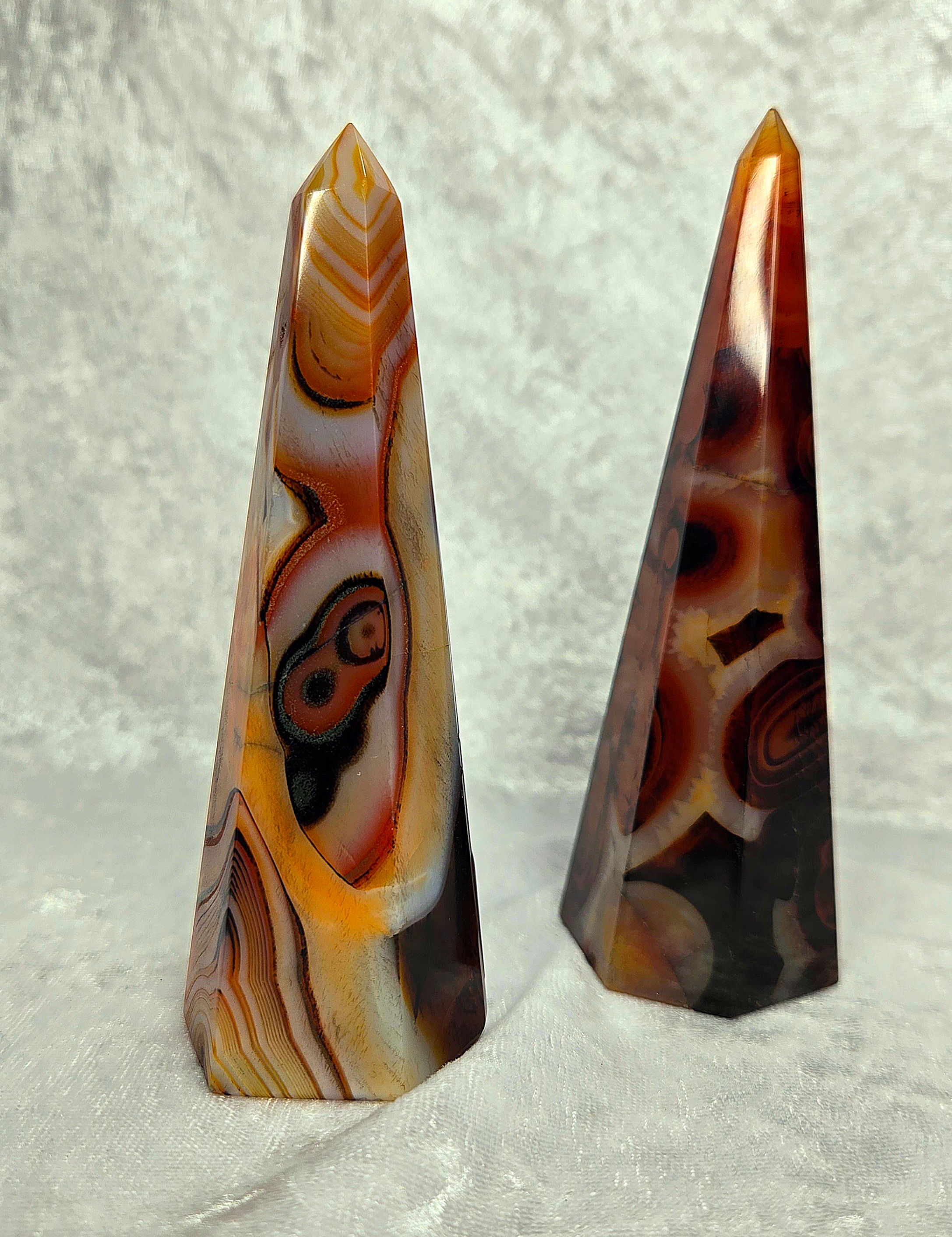 Sardonyx agate tower with layered orange, brown, and cream banding, approximately 4 to 5 inches tall.