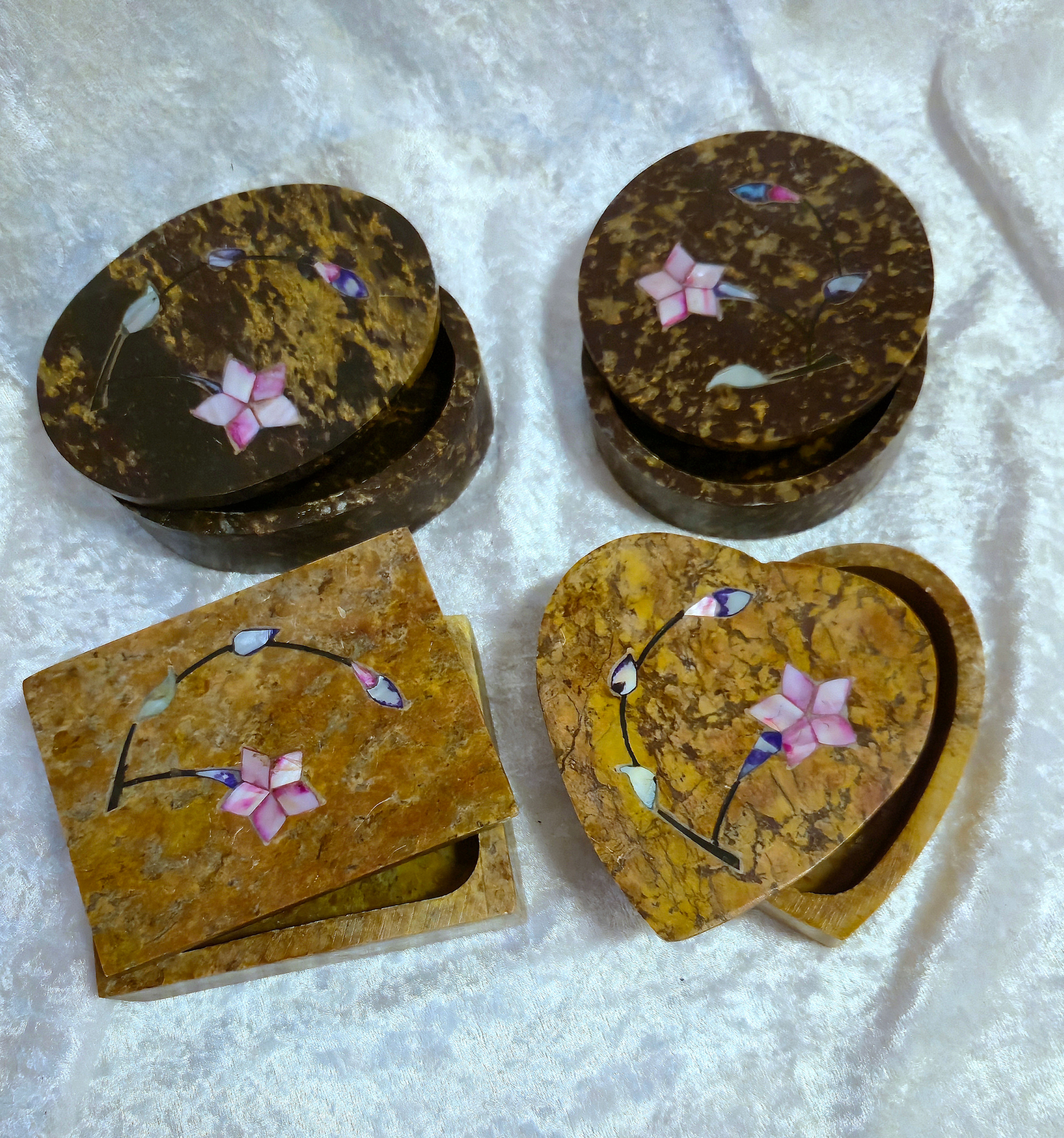 Four 4" soapstone boxes in assorted shapes—oval, round, rectangular, and heart—with delicate mother of pearl floral inlay.