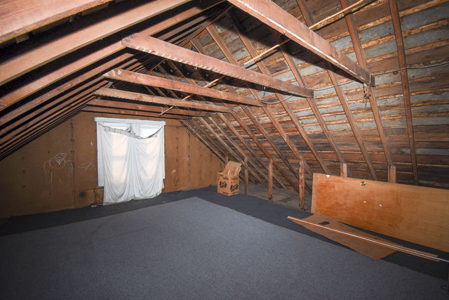 Unfinished attic space with pitched roof and window