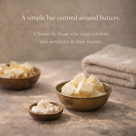 The image showcases an aesthetic arrangement of different butter samples displayed in wooden and metal bowls. They are set against a backdrop of a neutral-toned towel to evoke a feeling of comfort and simplicity.