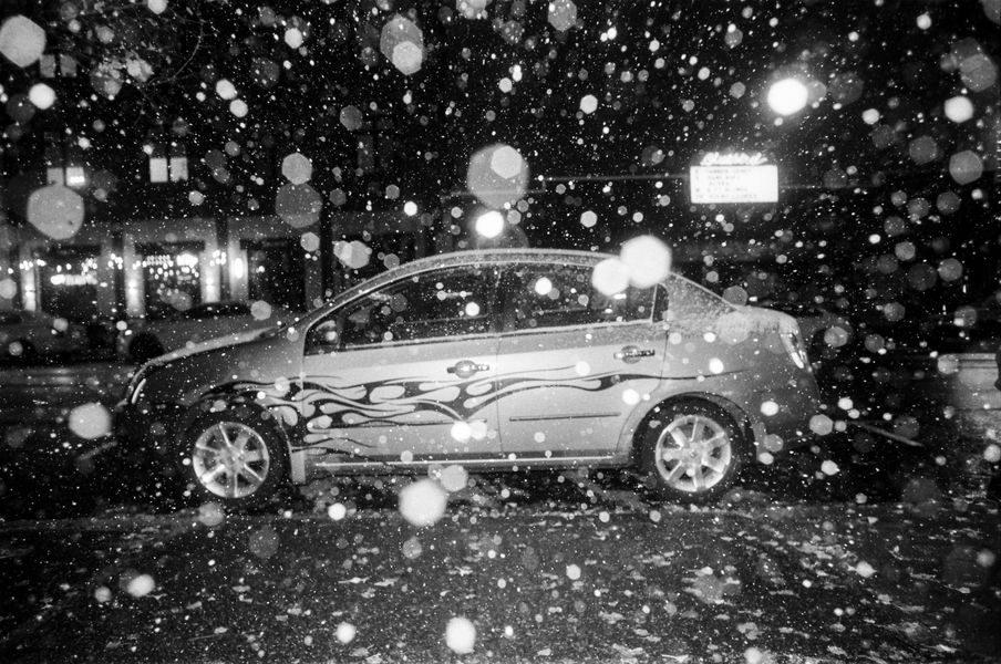 Film photo of a car at night in the rain