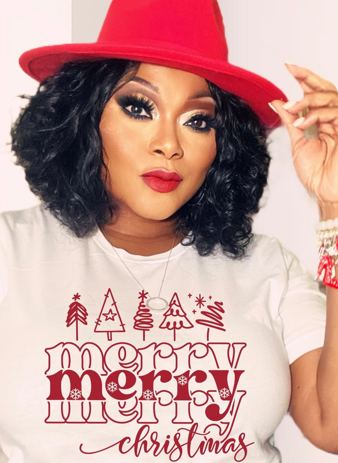 Woman wearing a cream shirt featuring the phrase "Merry Merry Merry Christmas" in red.