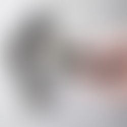 Close-up photo of a hand plugging in an electrical cord to an outlet.