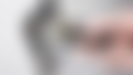 Close-up photo of a hand plugging in an electrical cord to an outlet.