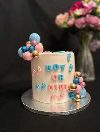 Gender reveal celebration cake feature boy or girl messaging