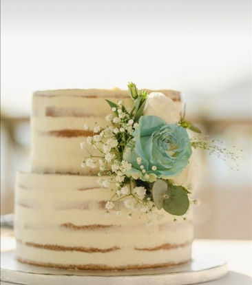 Simple two-tier naked cake topped with artificial blue flower