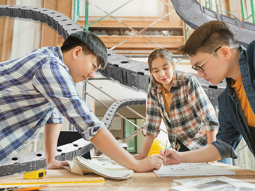 Three young students, possibly architects, are reviewing their notes at a construction site. Flexability products in the background.