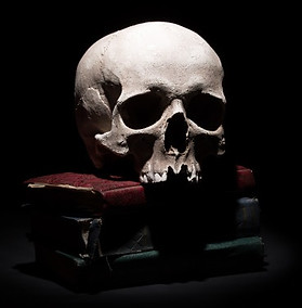 human-skull-old-books-black-background-b