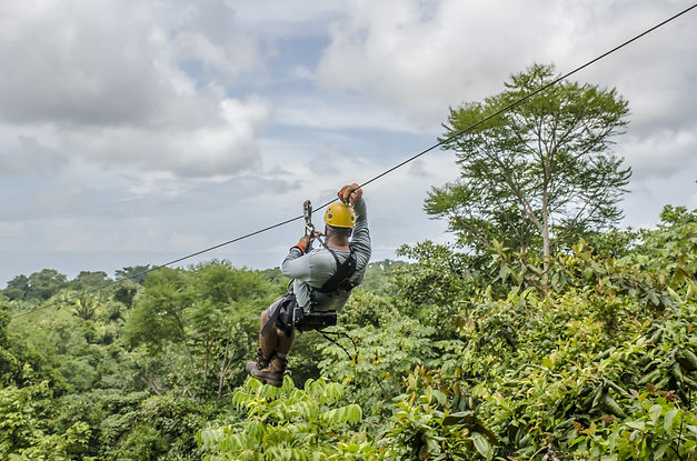 close-up-shot-man-hanging-sliding-zipline-beautiful-park-cloudy-sky.jpg