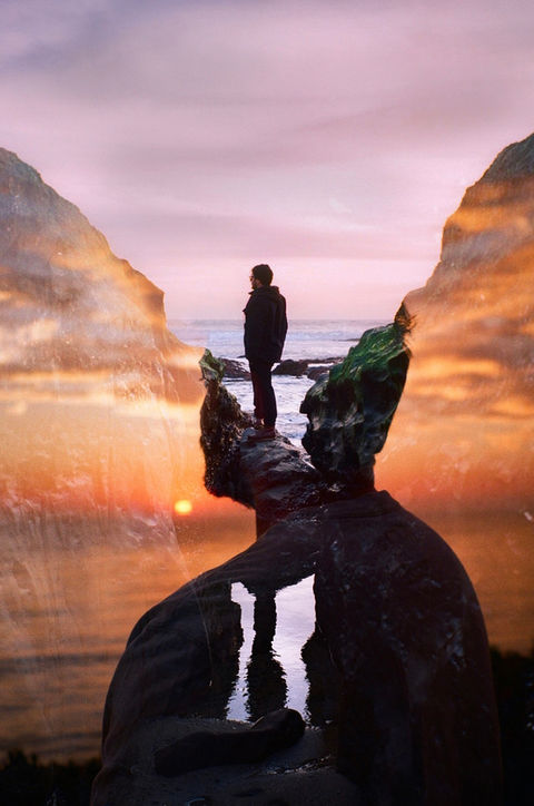 double exposure silhouette of man with orange sunset