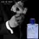 Thumbnail: ULRIC DE VARENS Night Eau de Toilette - 100 ml placed infront of a black background with a men wearing suit