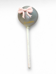 elegante grijze cake pop met roze strik en gouden details – elegant grey cake pop with pink bow and golden accents
