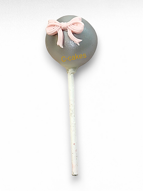 elegante grijze cake pop met roze strik en gouden details – elegant grey cake pop with pink bow and golden accents
