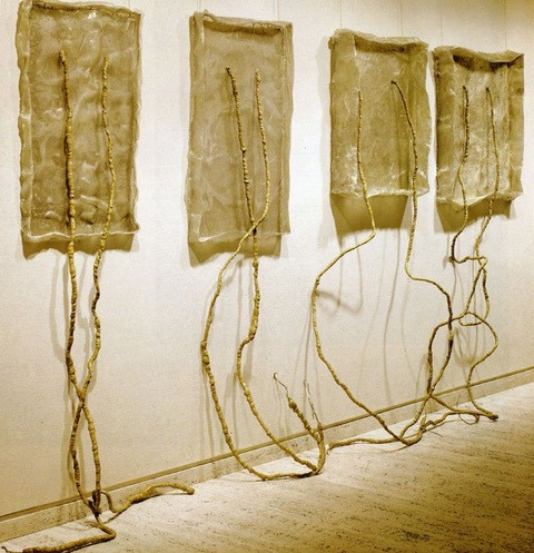 Artwork on wall with long pieces touching the floor.