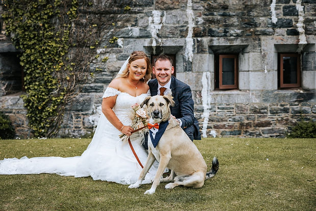 bride and groom and their dog at the wedding venue