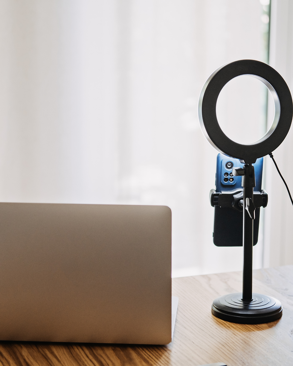 Laptop and ring light for social media services.