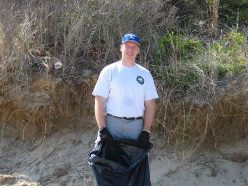 Evan Silverman holding trash bag after cleanup