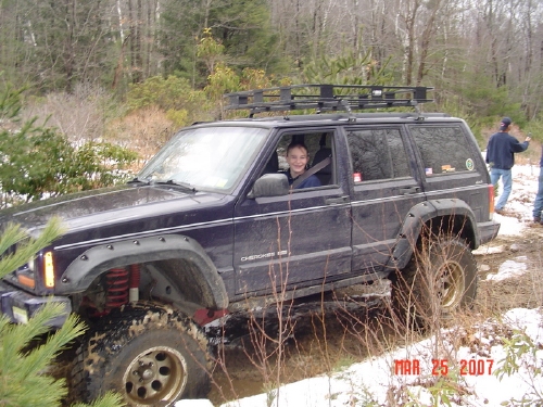 Man smiling in his Jeep Cherokee off-road