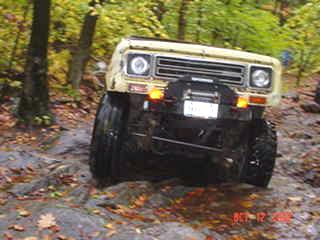 Off-road vehicle traversing rocky terrain