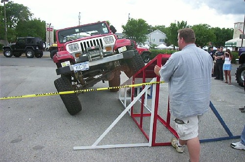 Red Jeep navigating obstacle course
