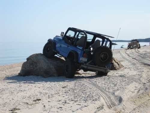 Blue Jeep on beach rock, Long Island Off Road