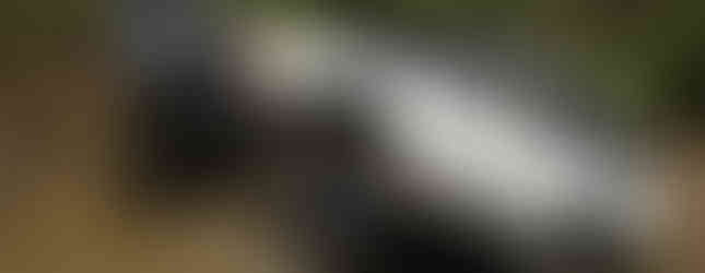 White Jeep Cherokee tackling muddy off-road trail