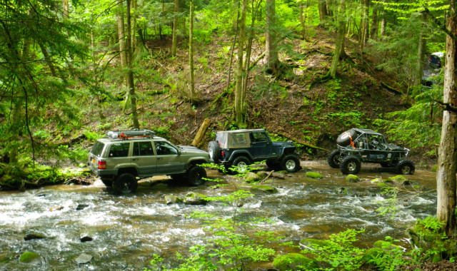 Jeeps and ATV crossing stream on Long Island Off Road trail