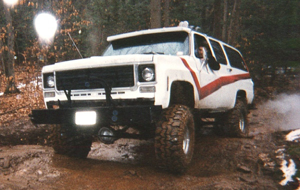White Chevy Suburban off-roading