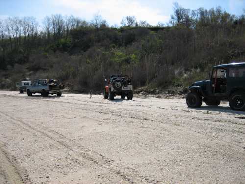 Off-road vehicles parked on sandy trail