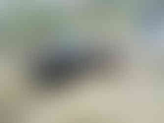 Green Jeep navigating rocky terrain